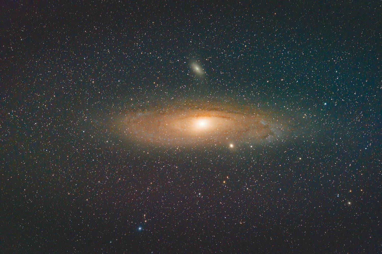 A stunning deep-space astrophotography image showcasing a grand spiral galaxy with a bright, glowing central bulge and prominent spiral arms threaded with orange-brown dust lanes, set against a densely star-filled dark sky. A smaller companion galaxy is visible above the main galaxy, along with numerous scattered background stars of varying brightness and color.